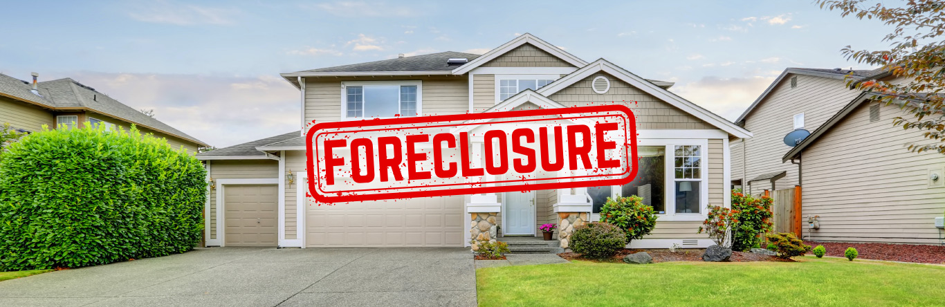 House with a red stamp that says foreclosure