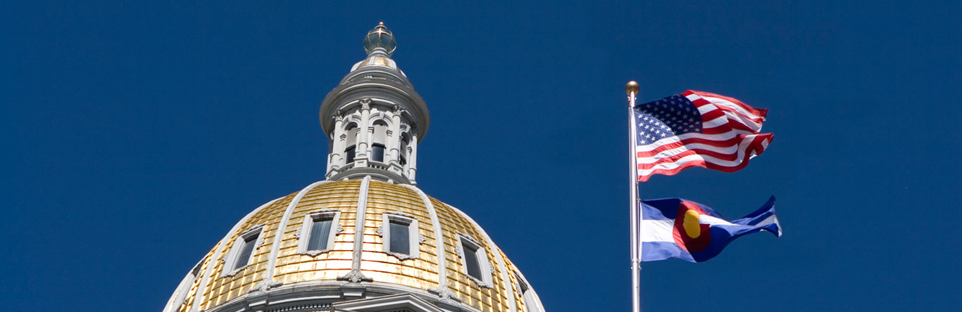 domed building next to U.S. and Colorado flags