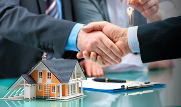 shaking hands over paperwork